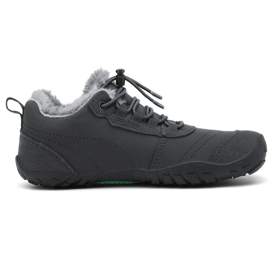 Zapatillas niña para invierno con suela plana zero drop y diseño ergonómico gris.